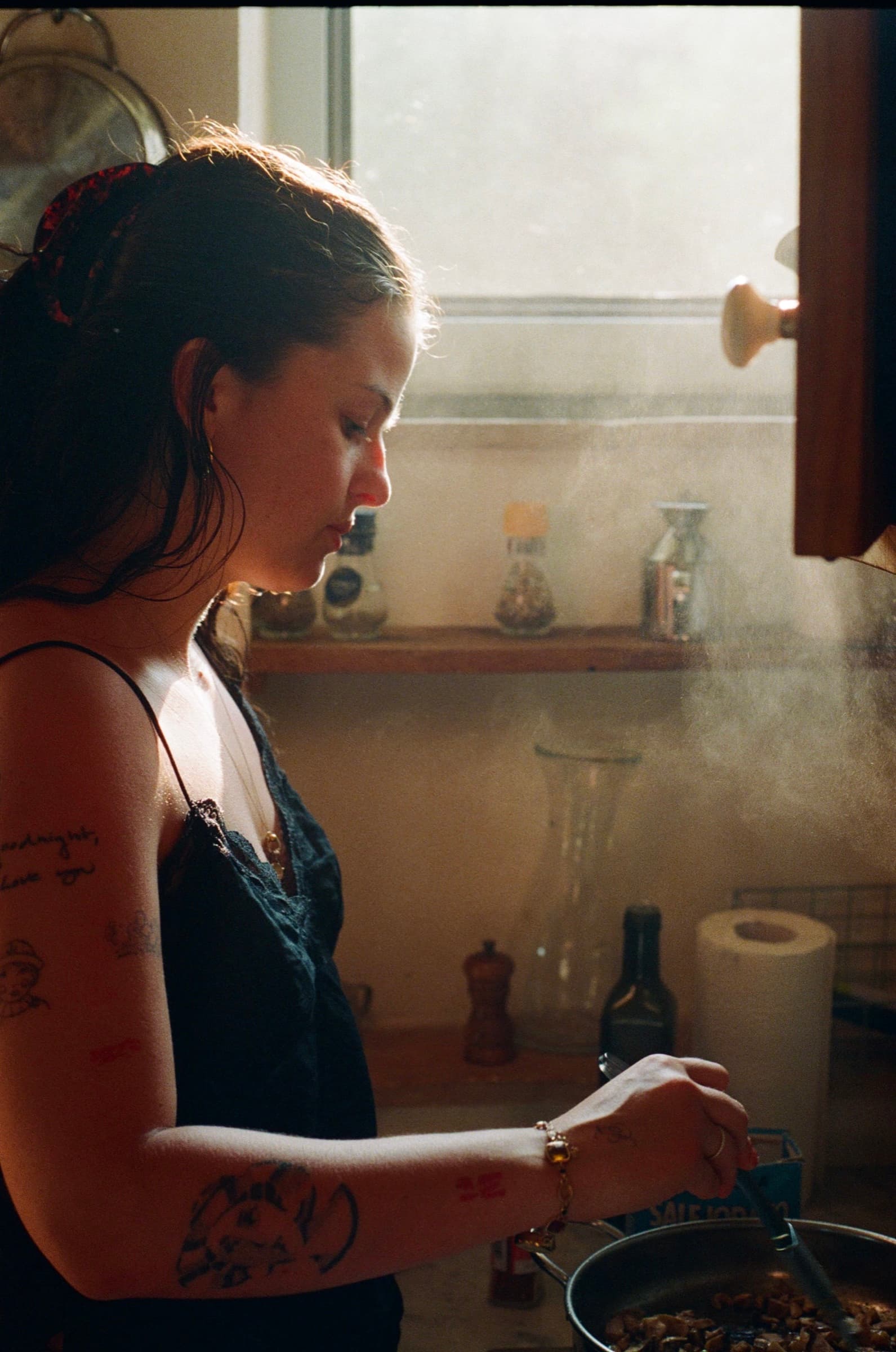 A cook working beside a steamy kitchen window